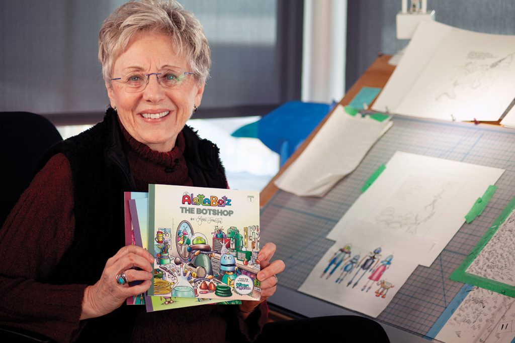 Lynn Johnston holding her three Alottabotz children's books. 